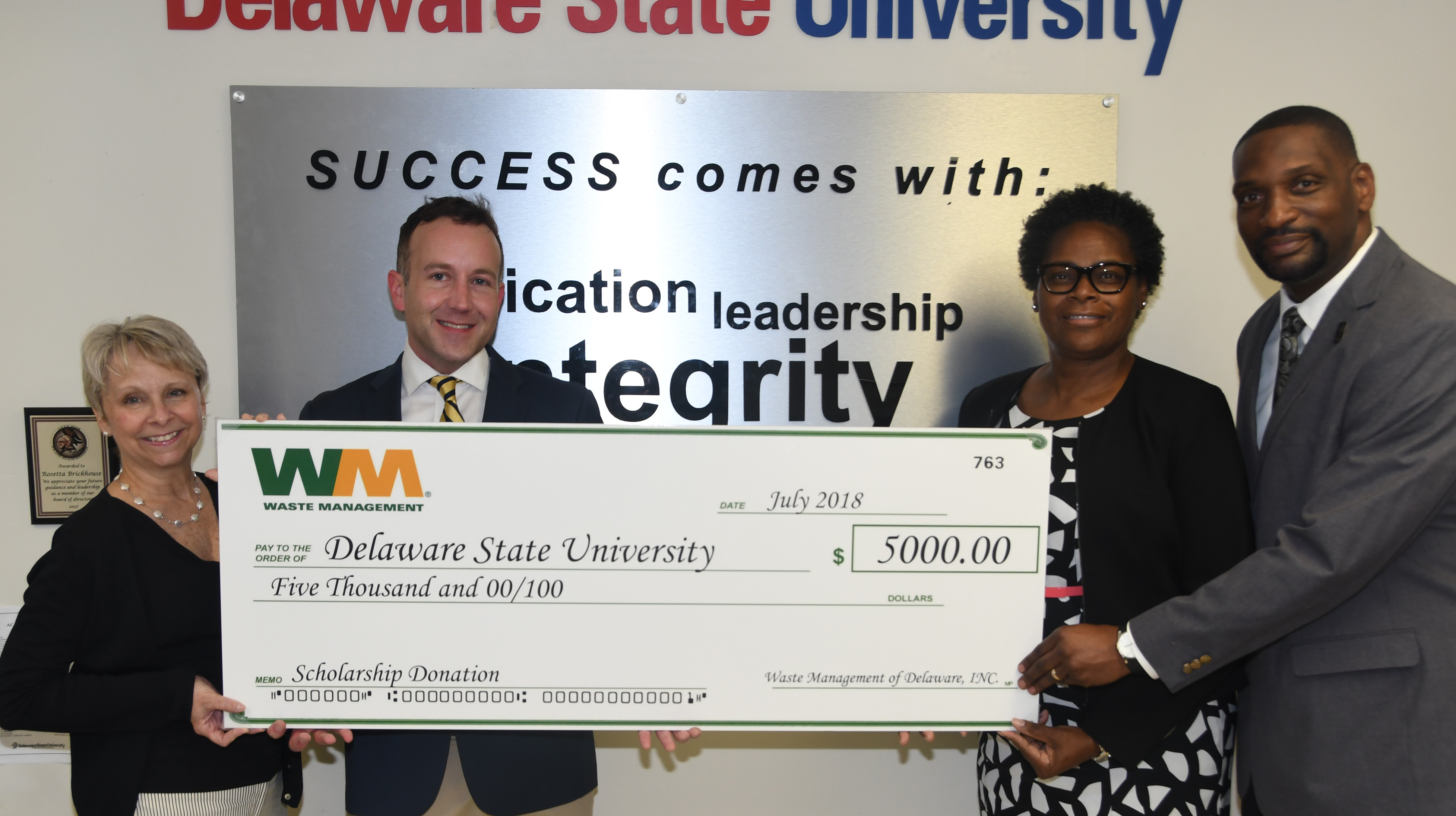 Waste Management donates scholarship check